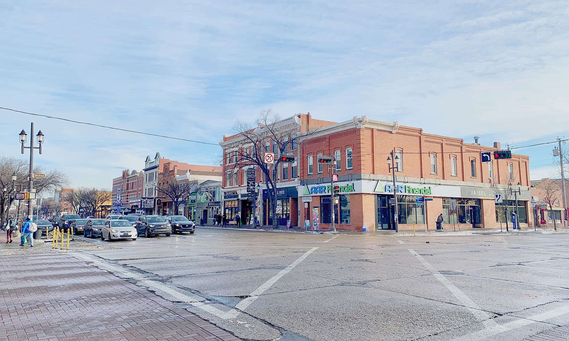 The intersection of Whyte Avenue and 104 Street in Old Strathcona, Edmonton, with a scramble crossing and storefronts