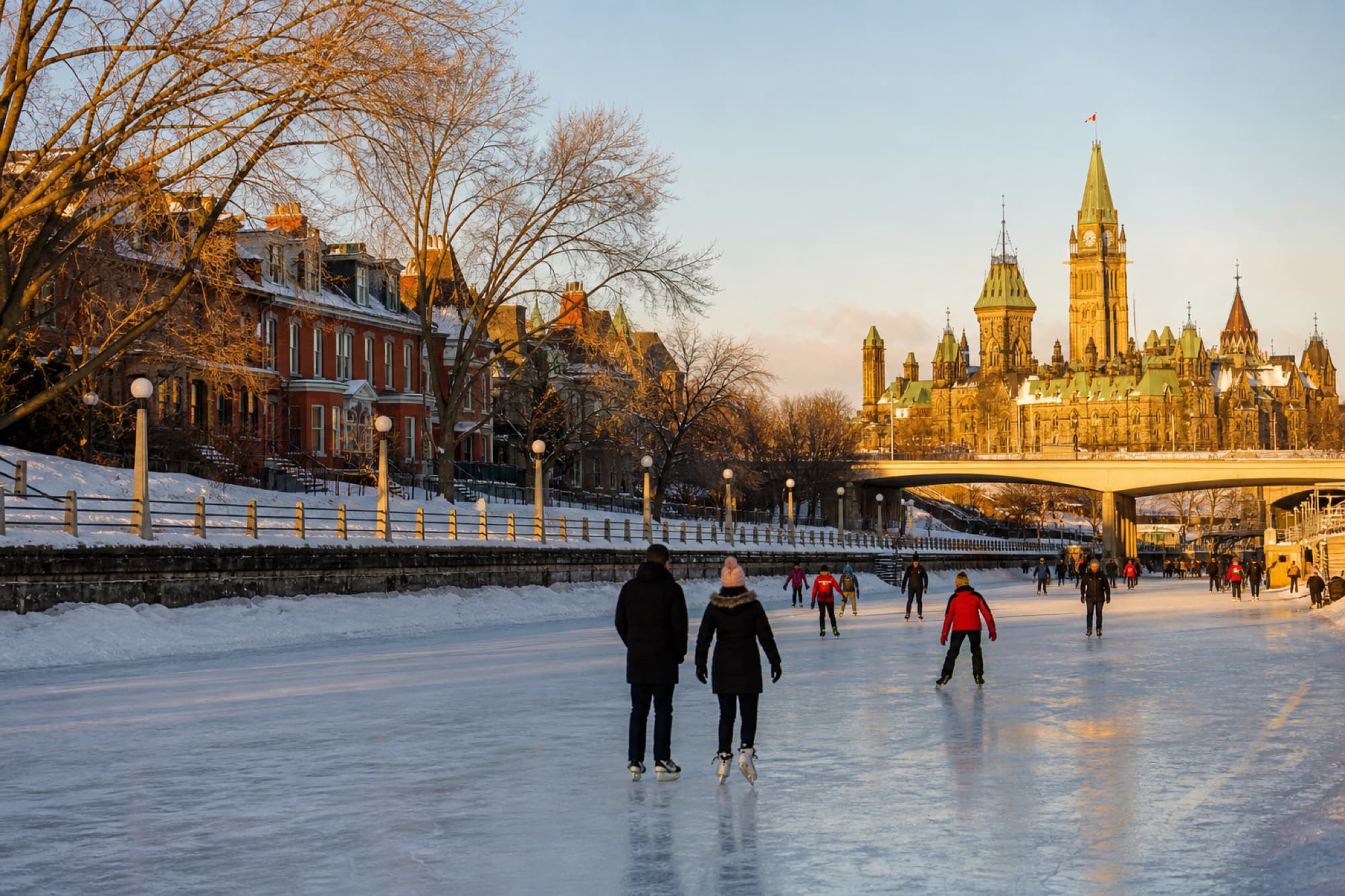 Skaters on the Rideau Canal with Parliament Hill in the distance
