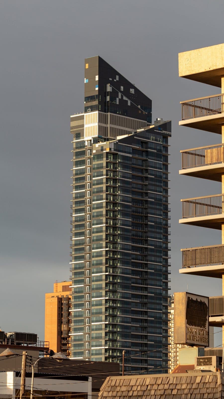 West Village Tower I, a dark glass residential tower in downtown Calgary
