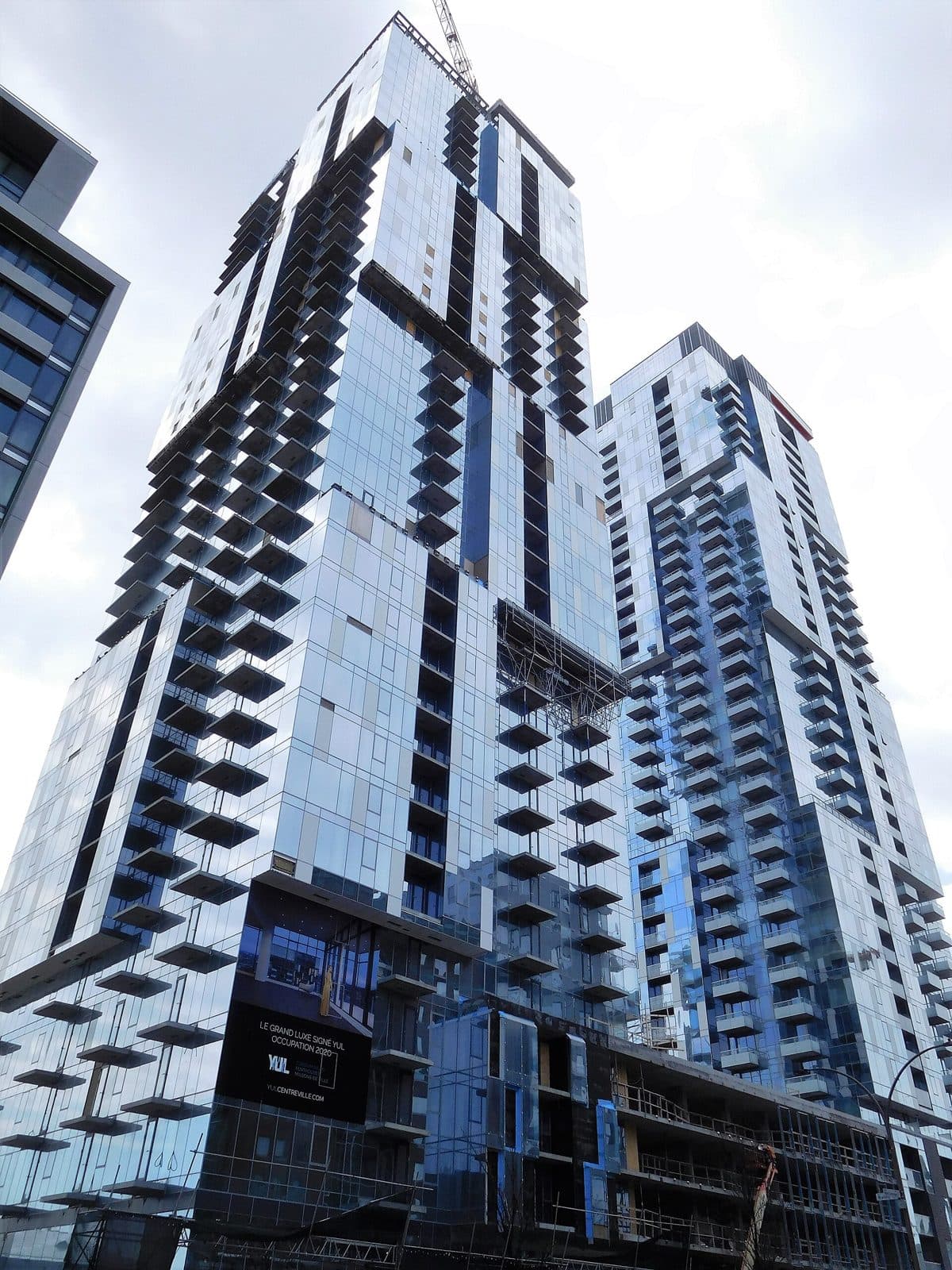 YUL's two blue glass towers with staggered balconies