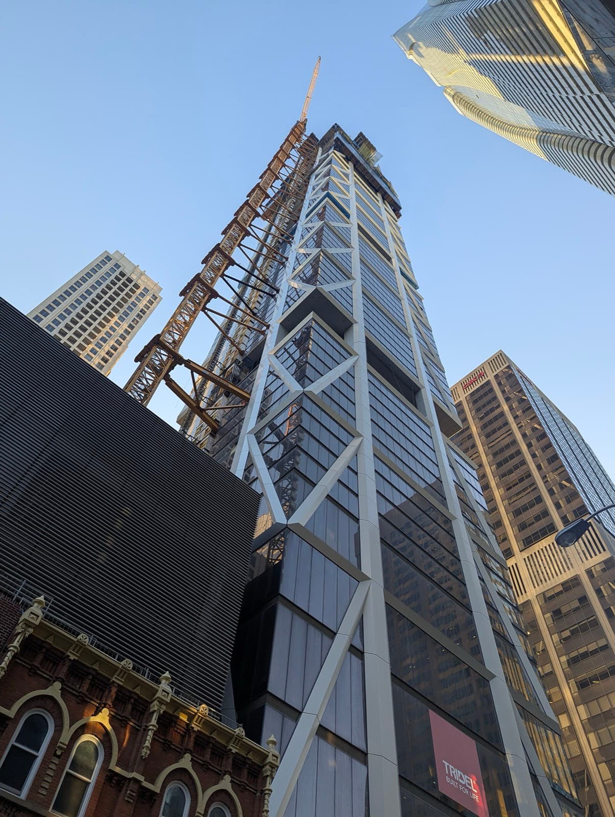 One Bloor West under construction at Yonge and Bloor, with a Tridel banner at its base