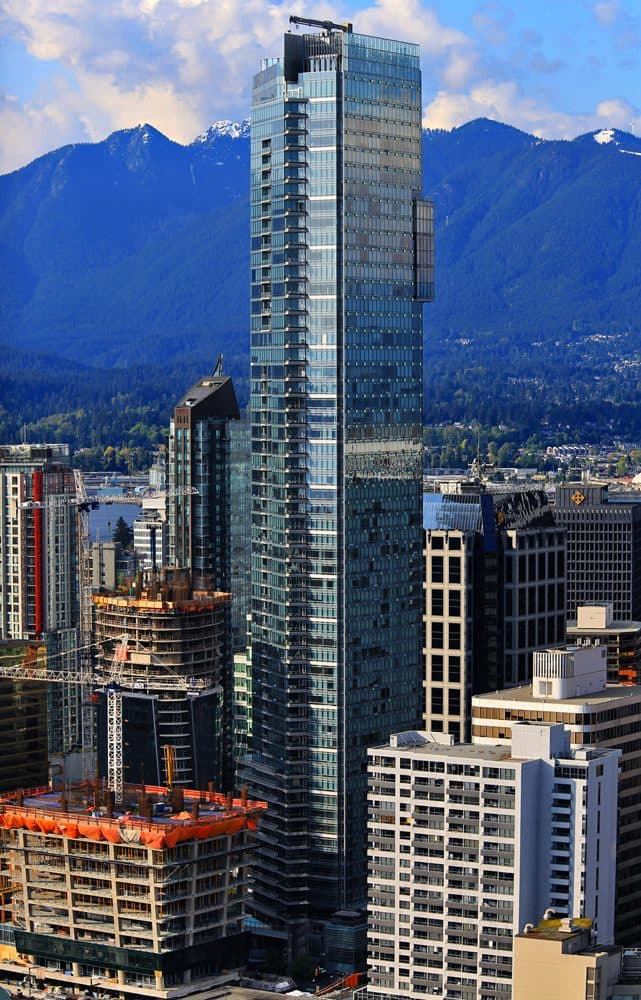 Living Shangri-La glass tower in downtown Vancouver with the North Shore mountains behind