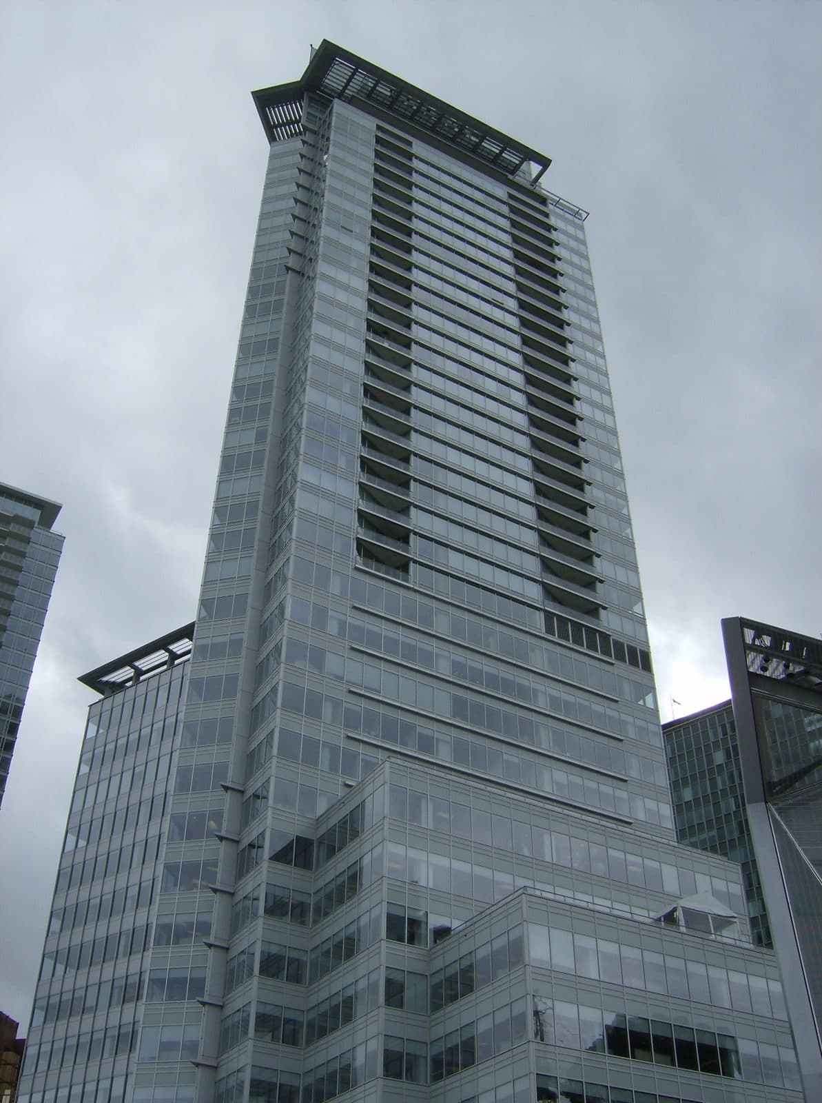 Looking up at the facade of Shaw Tower under grey skies