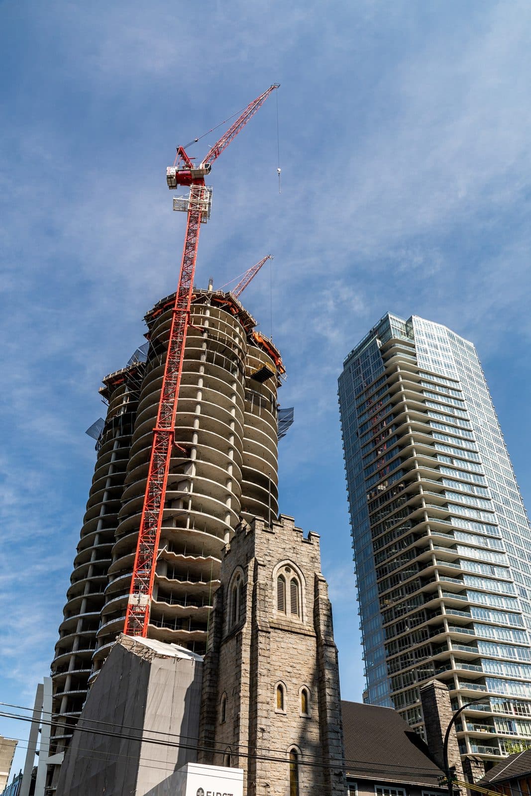 The Butterfly tower under construction behind the stone First Baptist Church in Vancouver