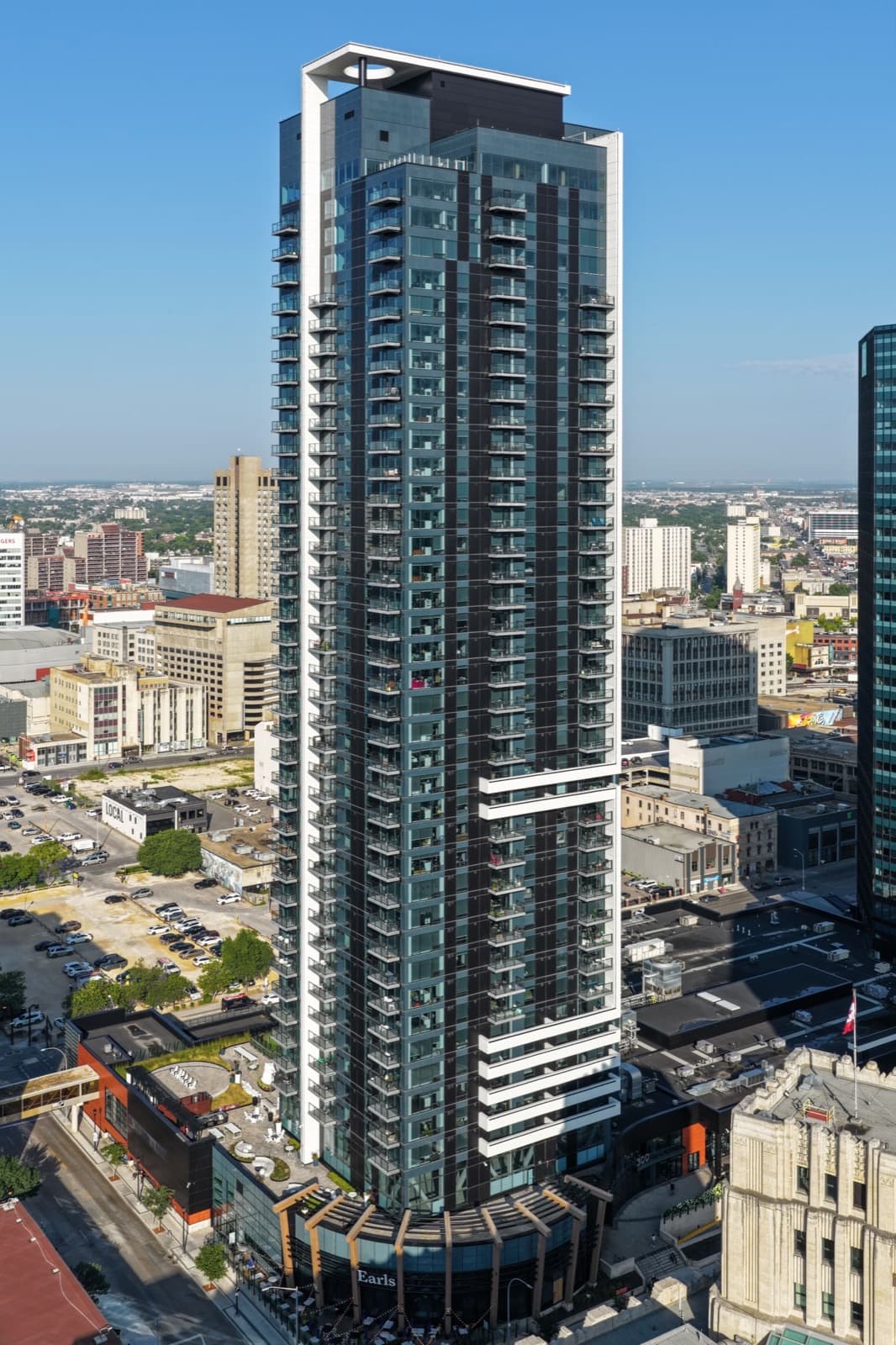 The black glass tower of 300 Main rising above downtown Winnipeg