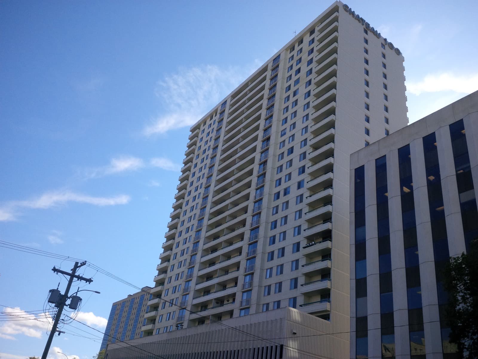 The balconied concrete tower of Chateau 100 seen from Donald Street