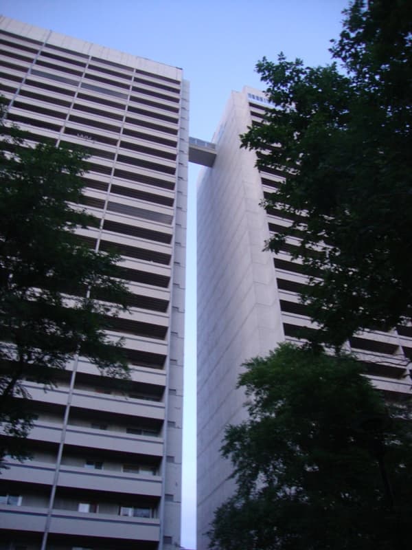 The two Holiday Towers from below, with the enclosed skyway linking them near the top