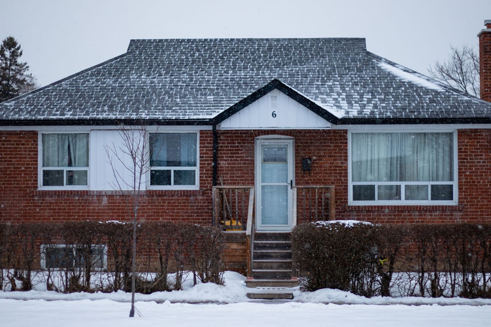 A snow-covered brick bungalow in Ontario